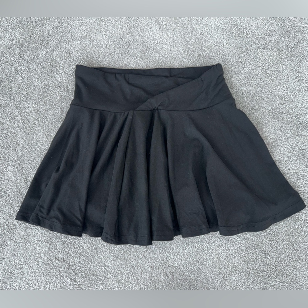 Black mini skirt with a sporty vibe